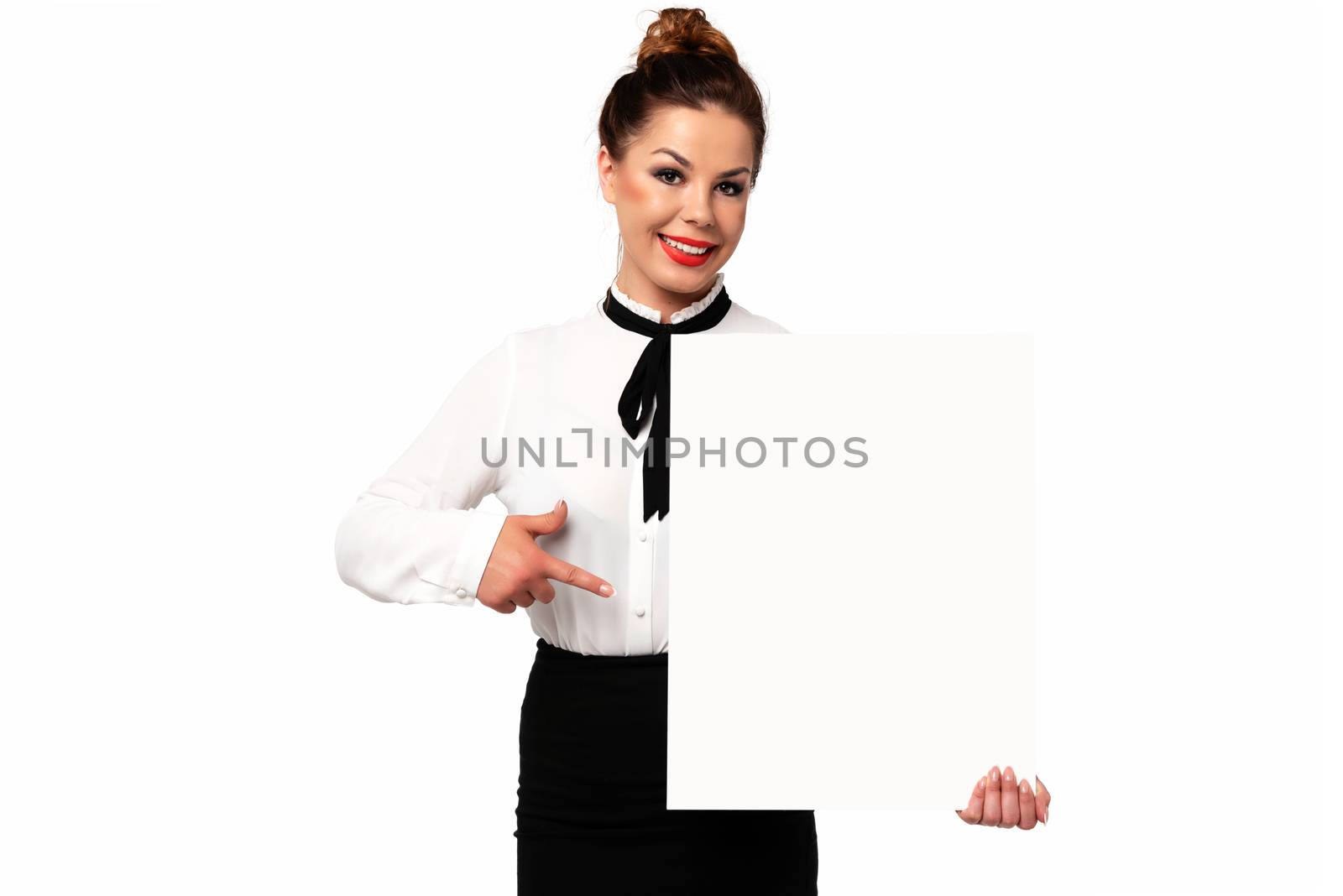 Beautiful business woman smiling and holding a white sign board with copy space for advertising and text on a white background.