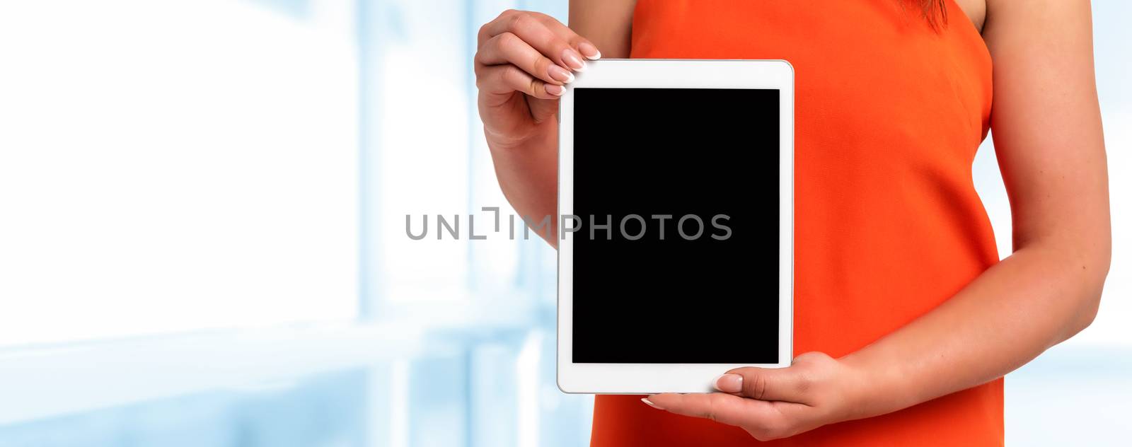 Technology advertising banner - woman in orange dress with perfect fingernails holding digital tablet with blank screen (copy space).