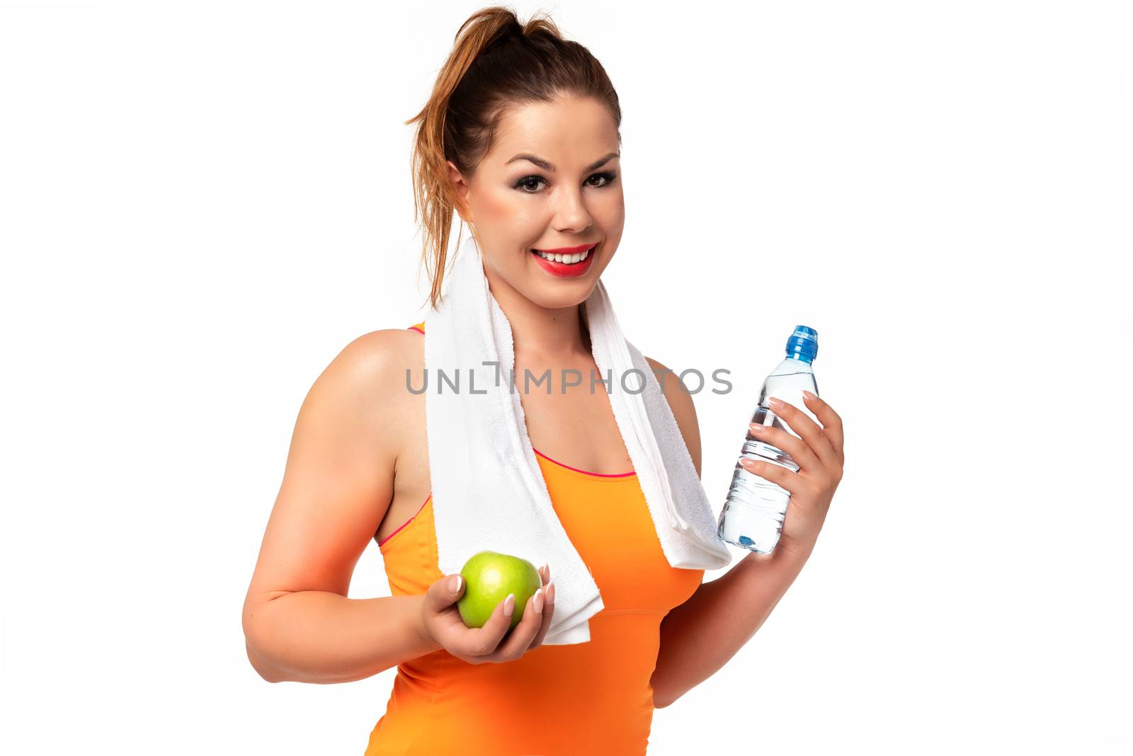 Healthy and Fitness lifestyle concept - beautiful young woman in sportswear with towel, water and green apple on a white background.