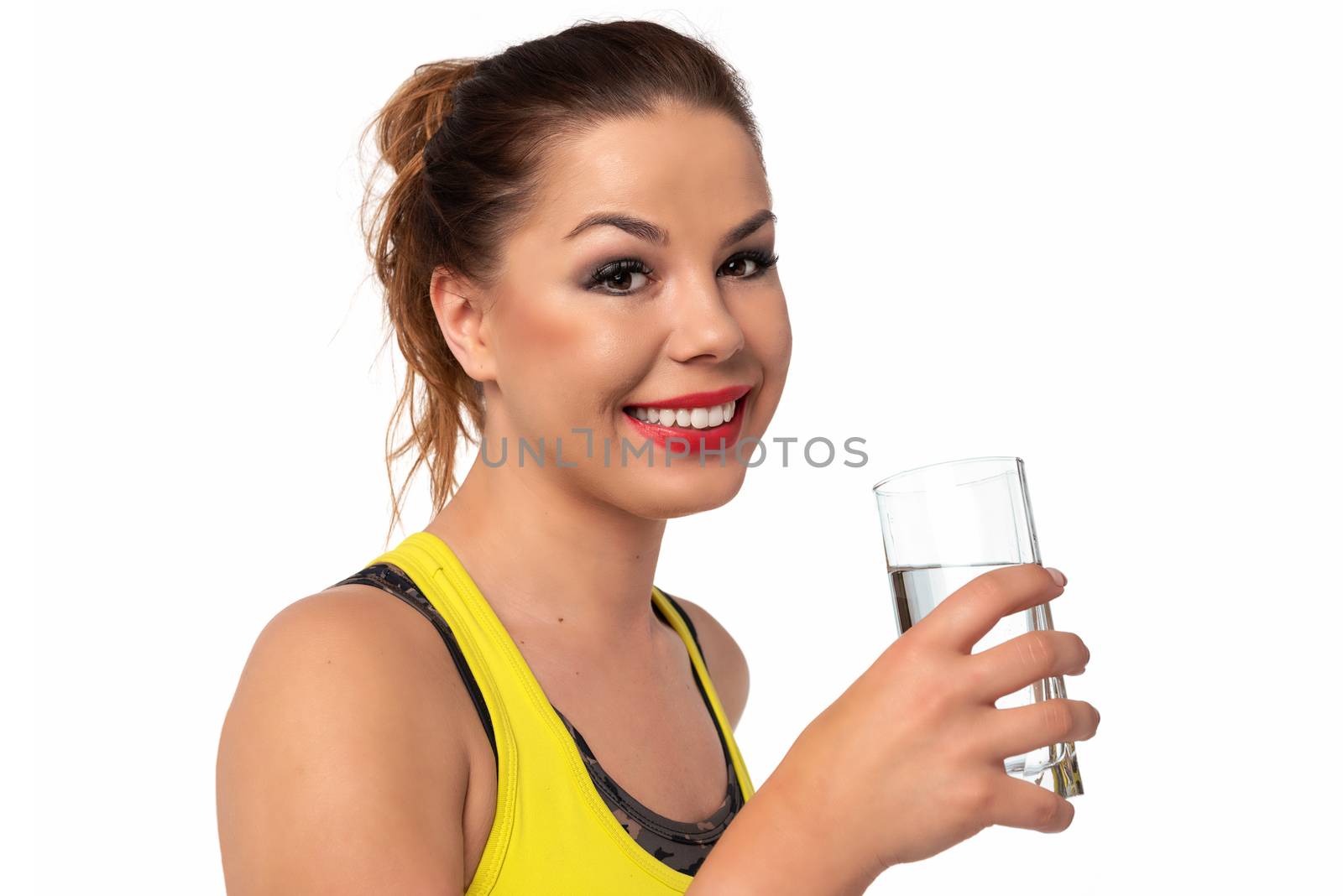 Healthy life concept - beautiful and young woman holds glass with fresh water on a white background.