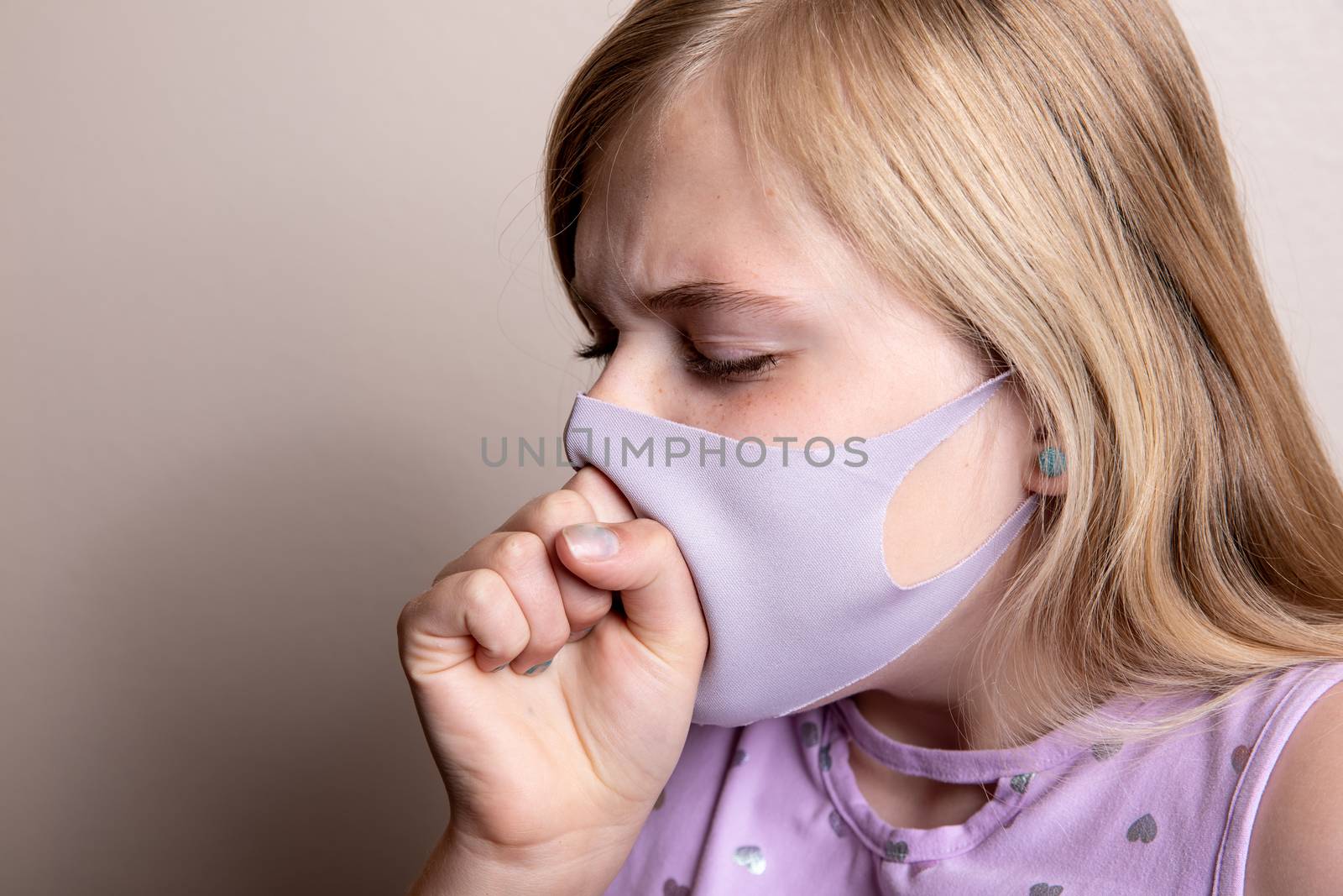 Girl trying to spread sickness by wearing he mask as she coughs