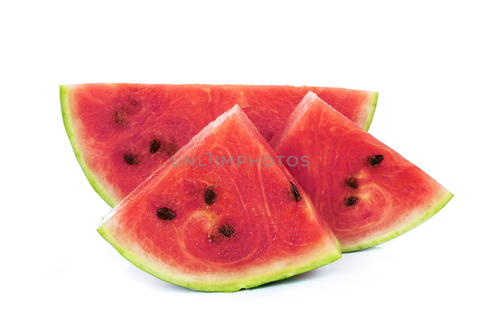 Slices of a fresh and ripe watermelon isolated on a white background in close-up.