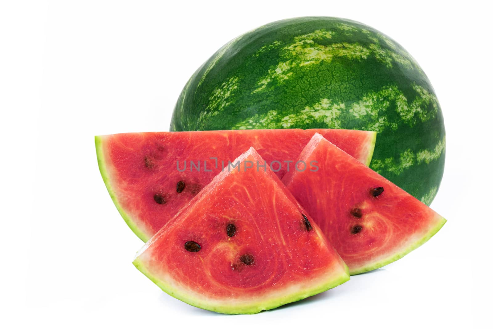 Slices and whole part of a fresh and ripe watermelon isolated on a white background in close-up.