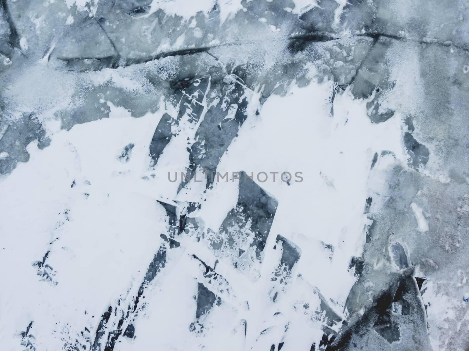 Broken ice on a frozen river. Water with shards of ice.