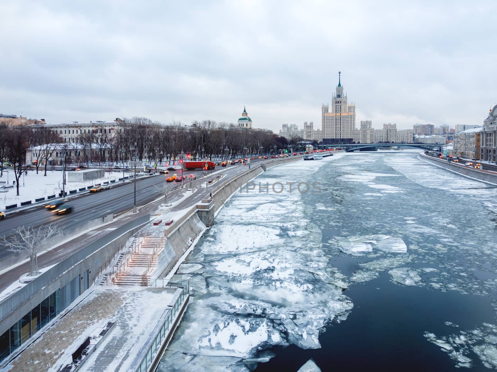 Winter cityscape with Moscow-river and famous Stalin's skyscraper on Kotelnicheskaya embankment. Russia.