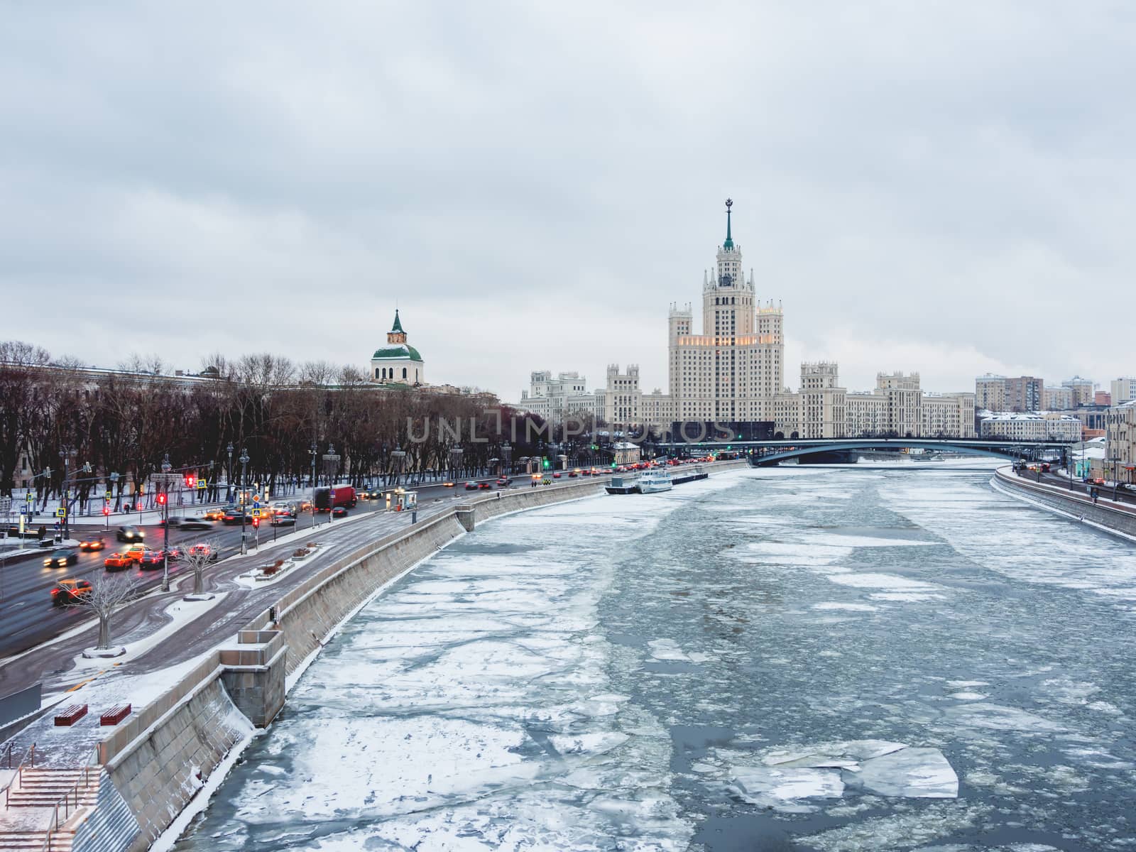 Winter cityscape with Moscow-river and famous Stalin's skyscraper on Kotelnicheskaya embankment. Russia.