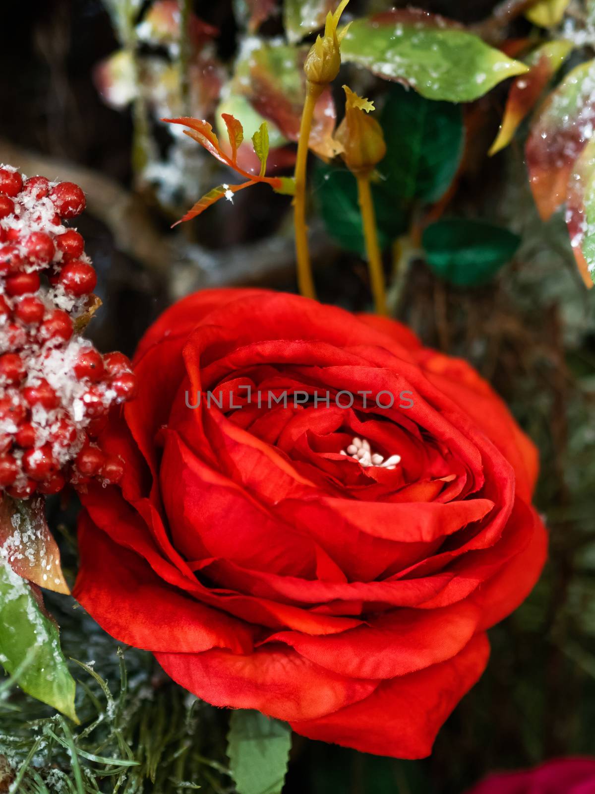 Elegant red rose flower, made of fabric with sequins. New Year decoration for Christmas tree.
