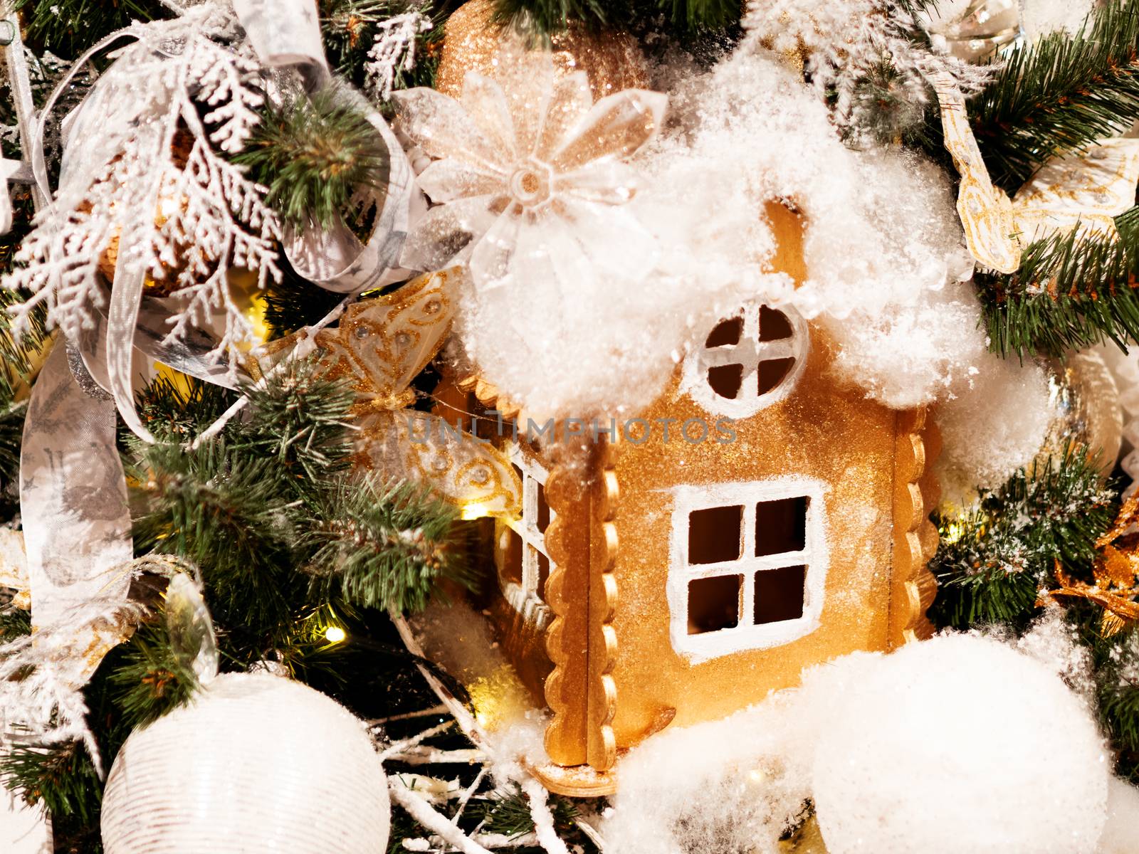 Golden hand made house made of cardboard. Bright shiny New Year decoration for Christmas tree.