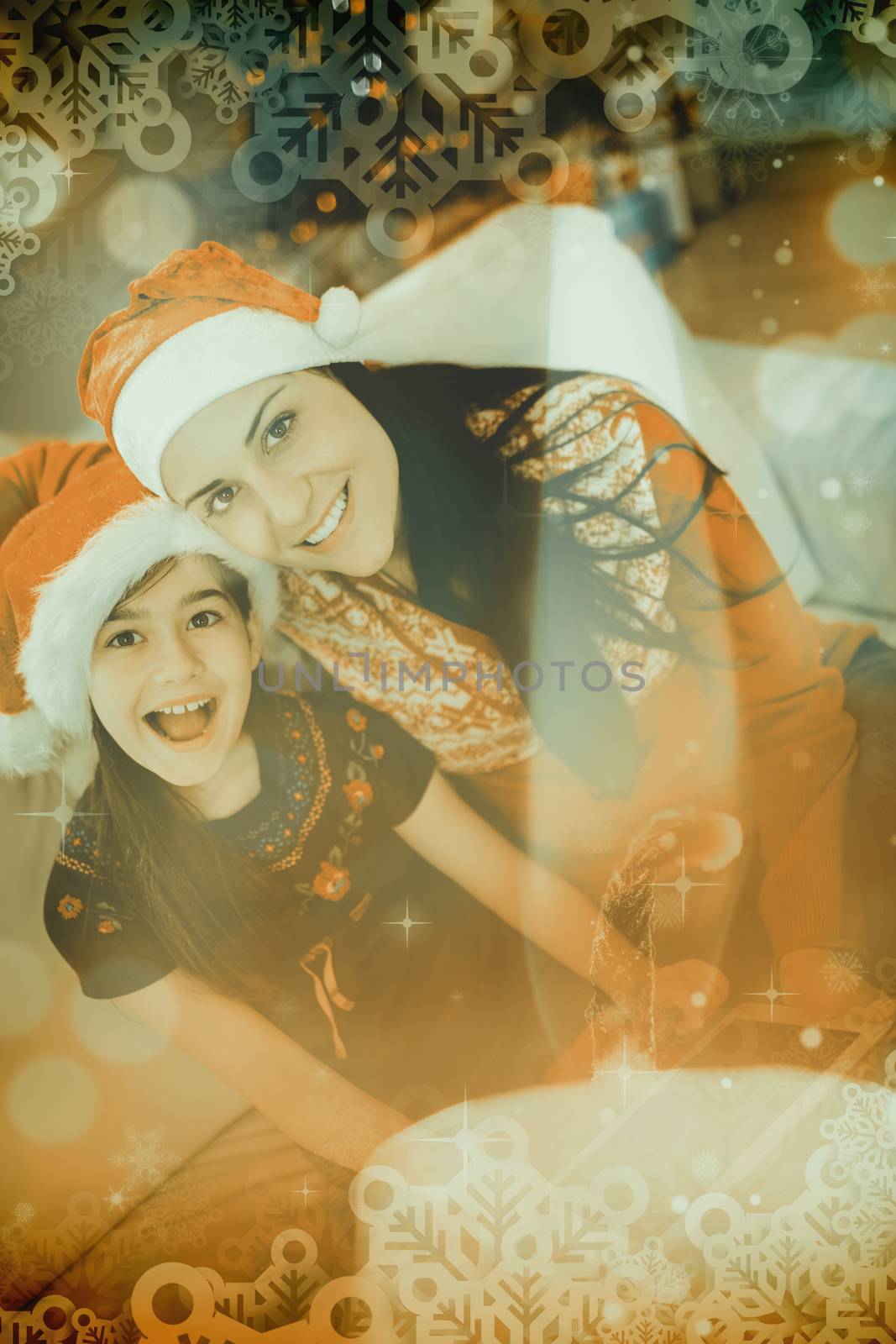 Festive mother and daughter using tablet pc against candle burning against festive background