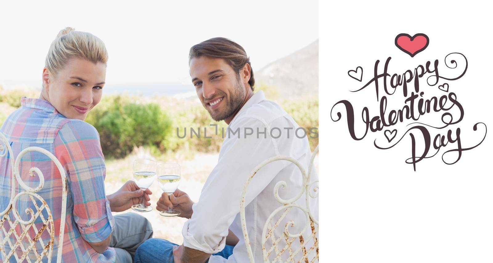 Happy young couple sitting in the garden enjoying wine together against happy valentines day