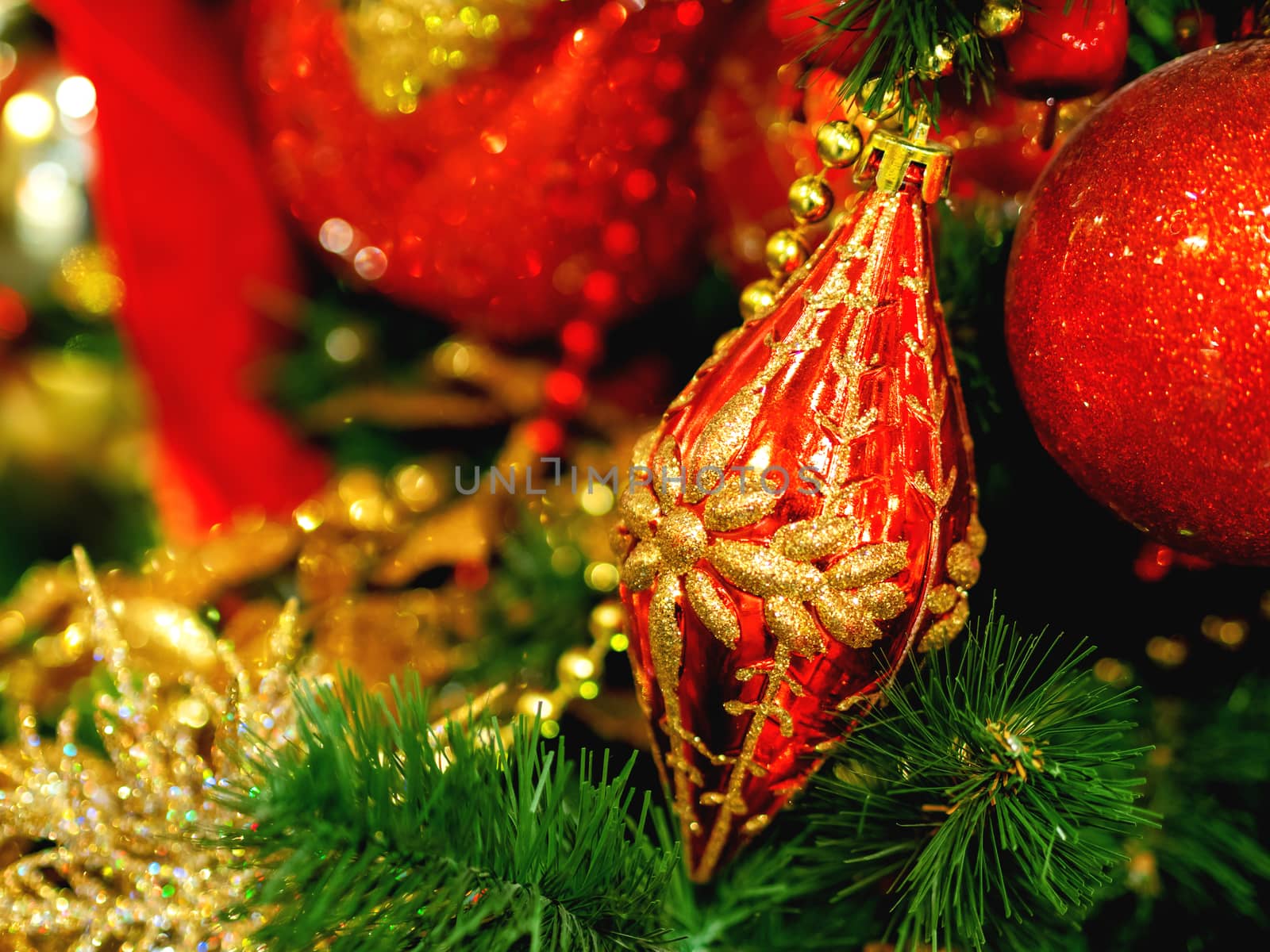 New Year red decoration with golden ornament on Christmas tree. Holiday decorations.