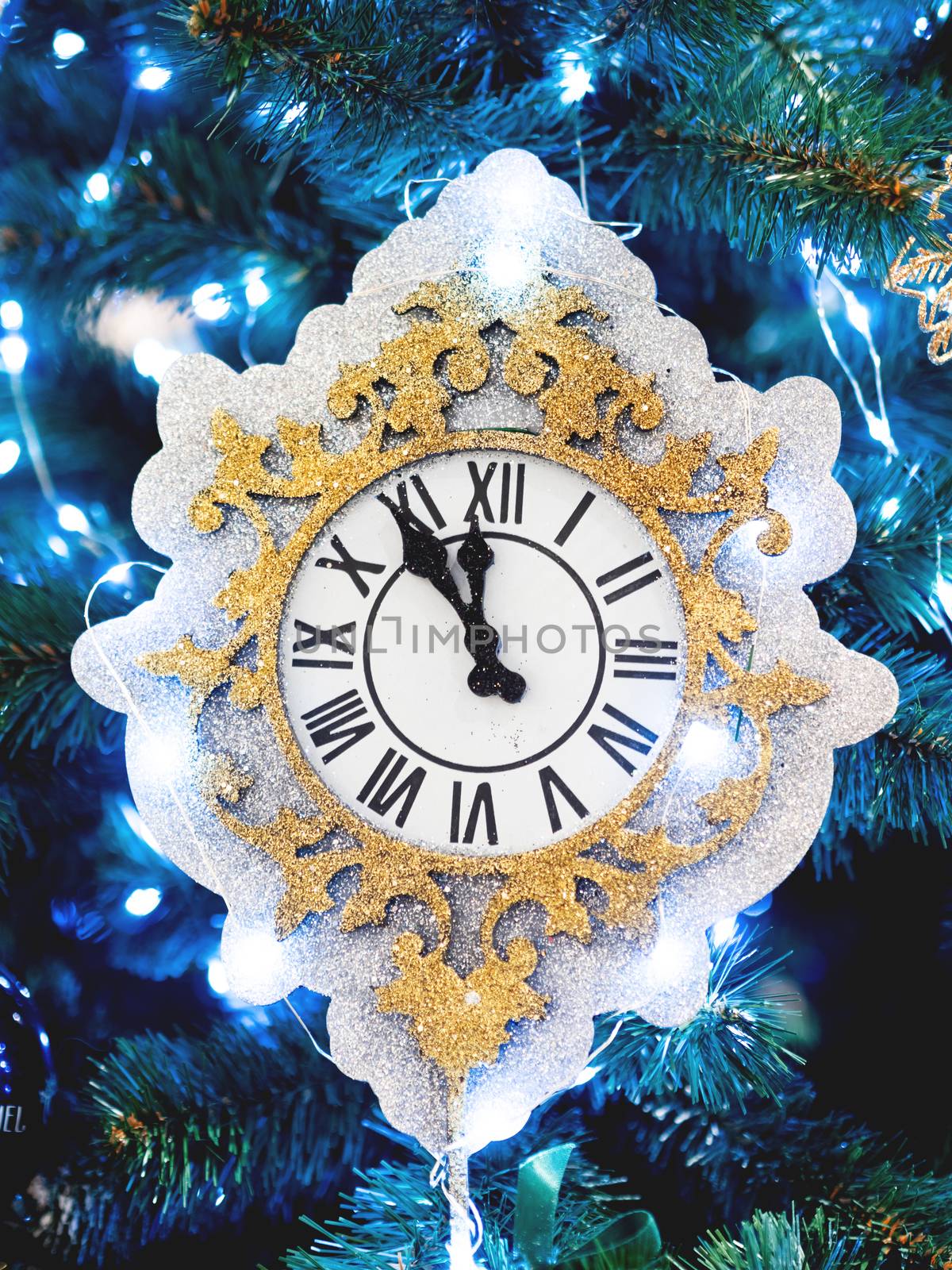Decorative watch made of spangles. New Year decoration for Christmas tree.