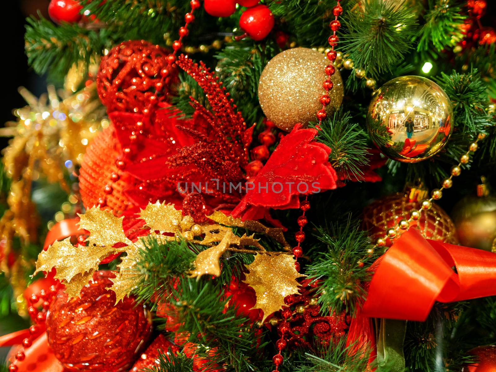 Elegant red flower, made of fabric with sequins. New Year decoration for Christmas tree.
