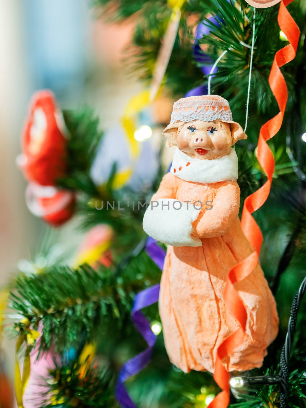 Old fashioned New Year decoration for Christmas tree. Figure of pig made of cellulose wadding. Symbol of 2019 year. by aksenovko