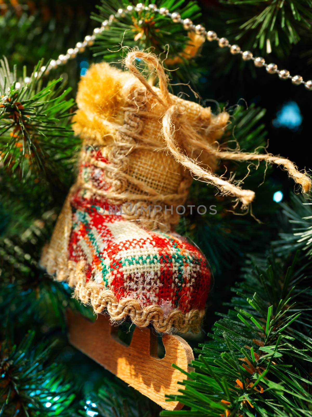 Hand made decoration for Christmas tree. Decoration made of tartan fabric with spangles for New Year celebration.