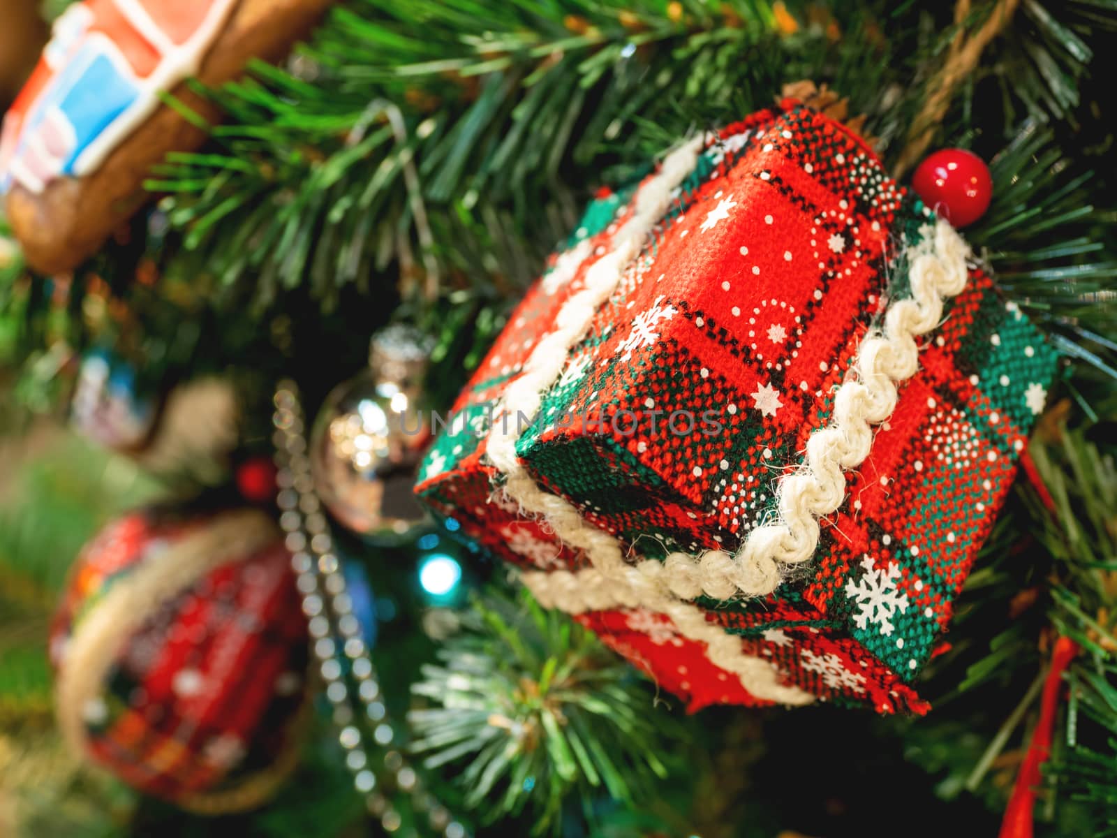 Hand made decoration for Christmas tree. Decoration made of tartan fabric with spangles for New Year celebration.