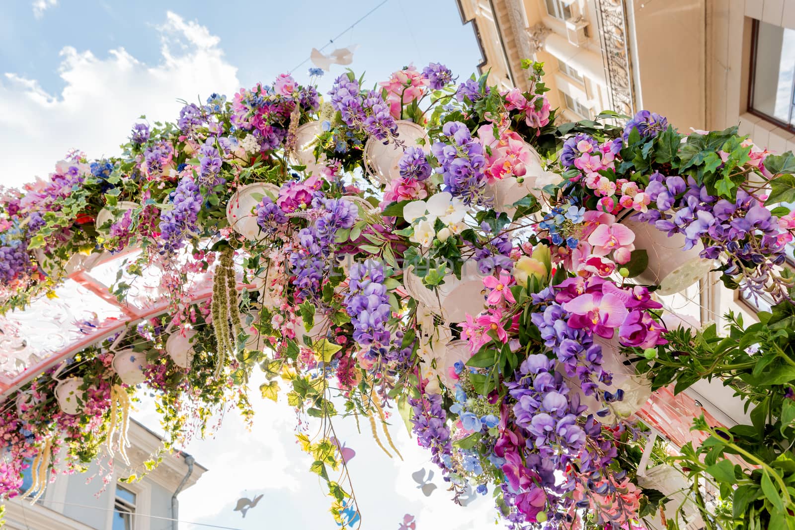Street festival "Moscow Spring" in historical center of Moscow city. Flower decoration of colorful easter fair.