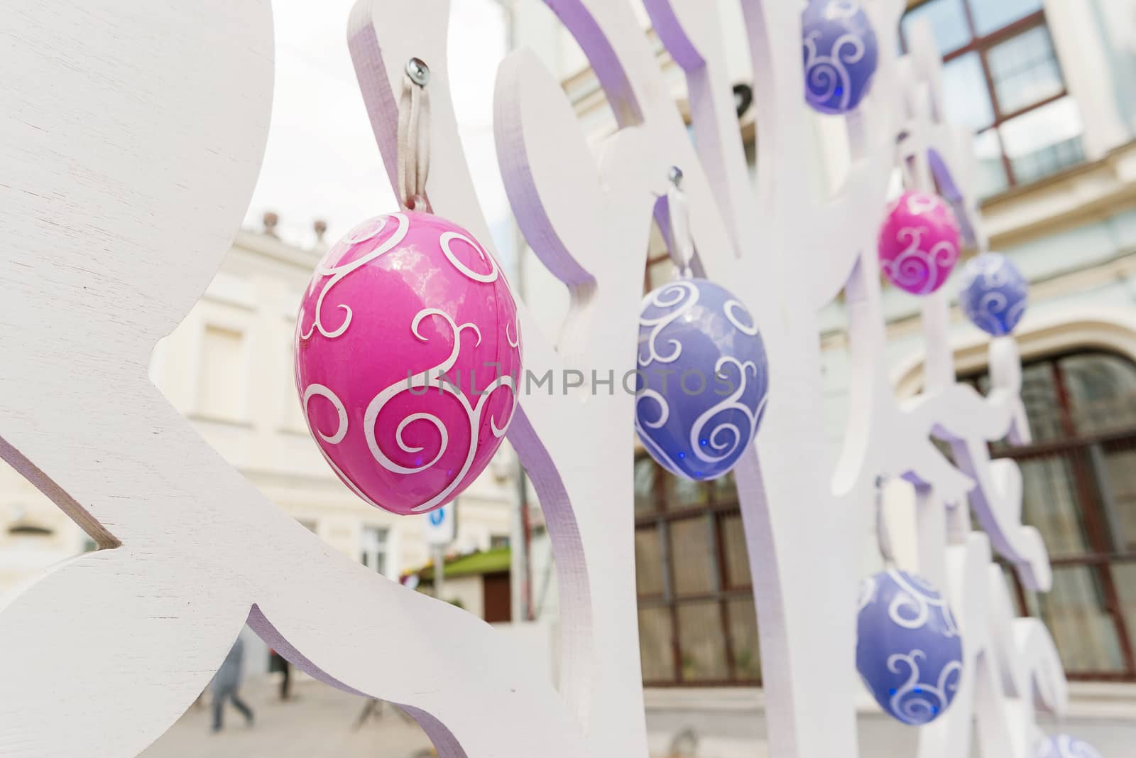 Street festival "Moscow Spring". Easter decoration of colorful fair. People walking on sunny day.