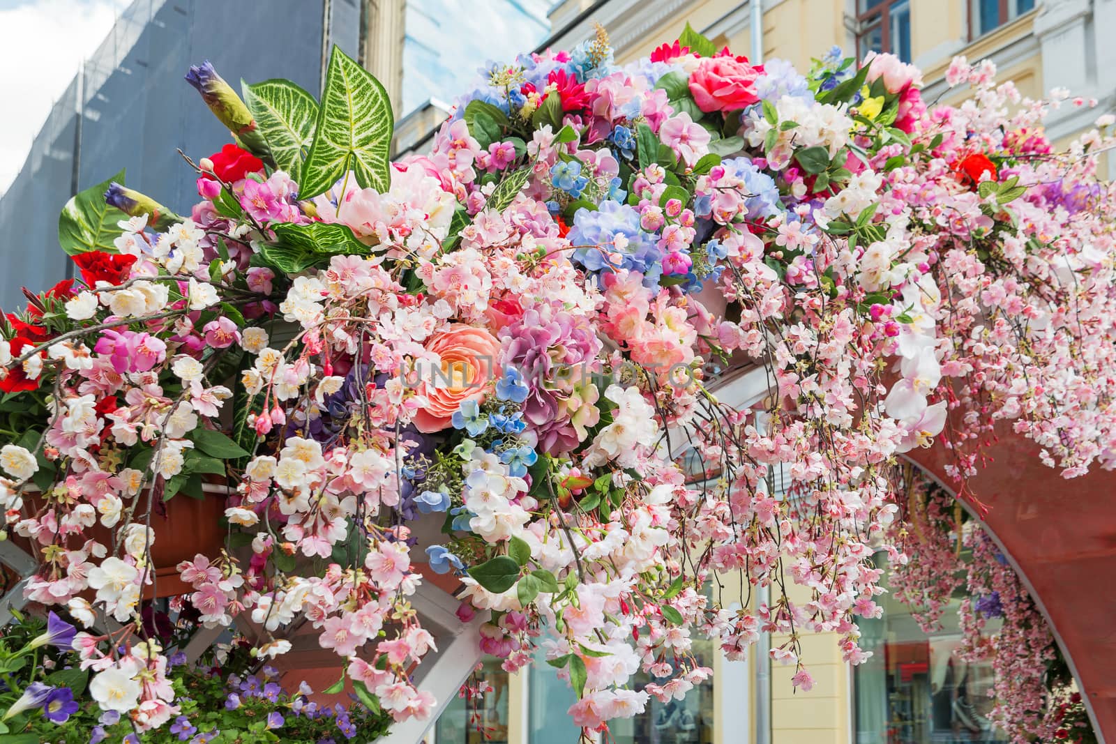 Street festival "Moscow Spring" in historical center of Moscow city, Russia. Flower decoration of colorful easter fair.
