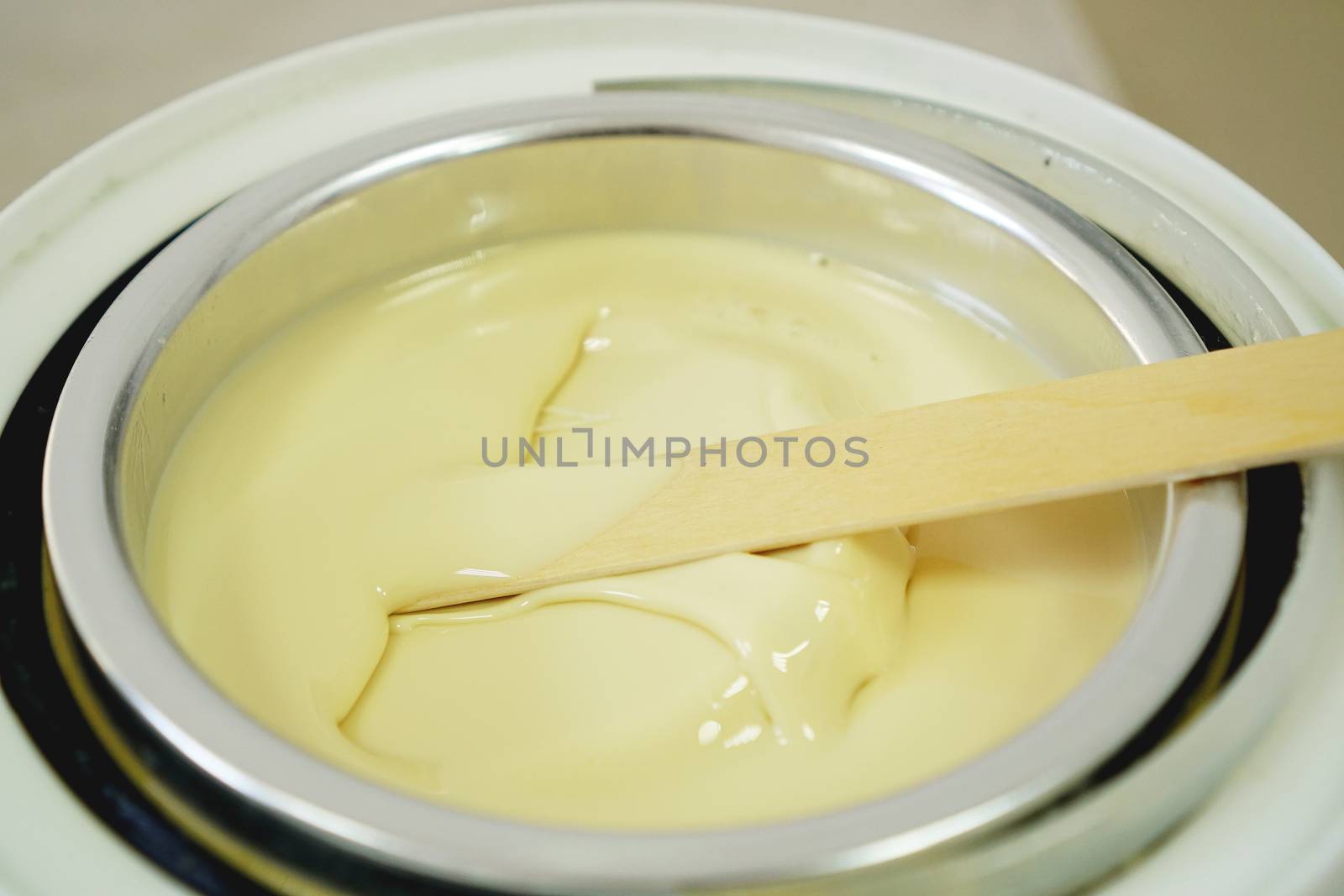 Preparation of wax for shugaring. Close-up wax for depilation is heated and melted in a round container