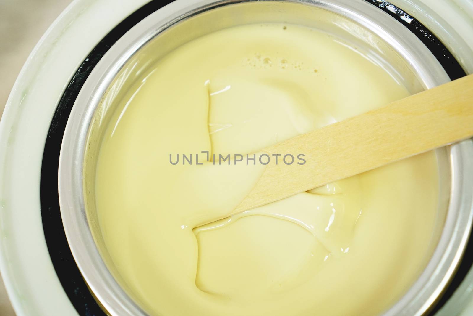 Preparation of wax for shugaring. Close-up wax for depilation is heated and melted in a round container