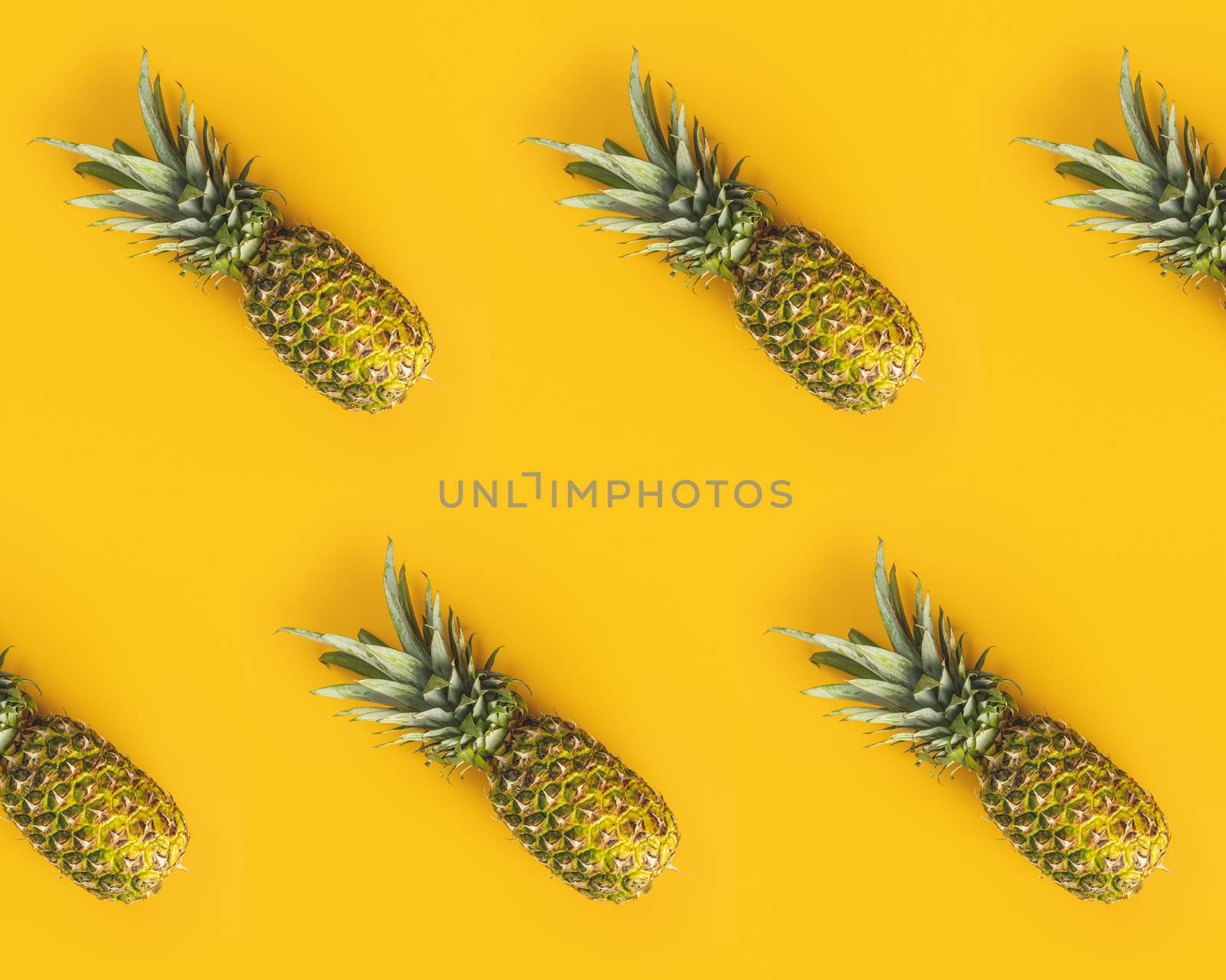 Fresh ripe pineapples on yellow background. Summer concept. Crea by ArtSvitlyna