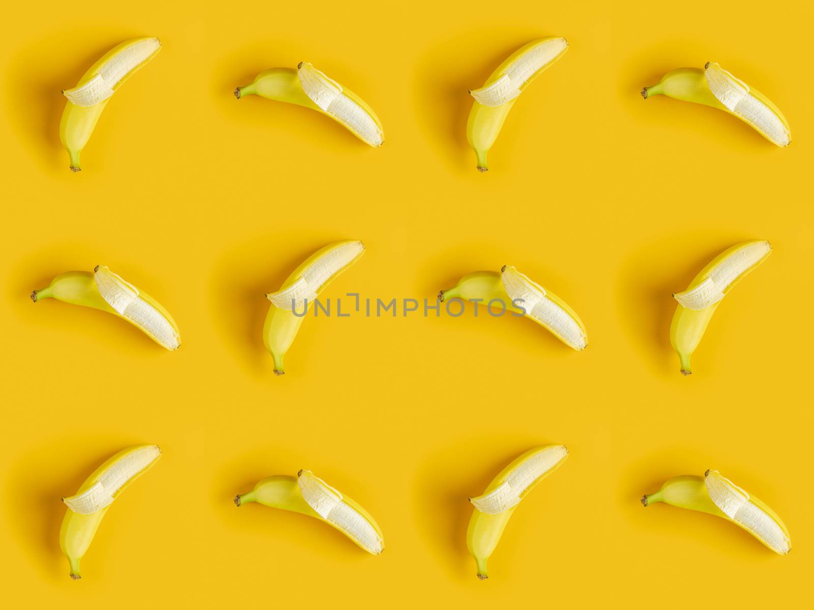 Tropical abstract background. Juicy ripe banana pattern on yellow background top.  Seamless pattern with bananas.