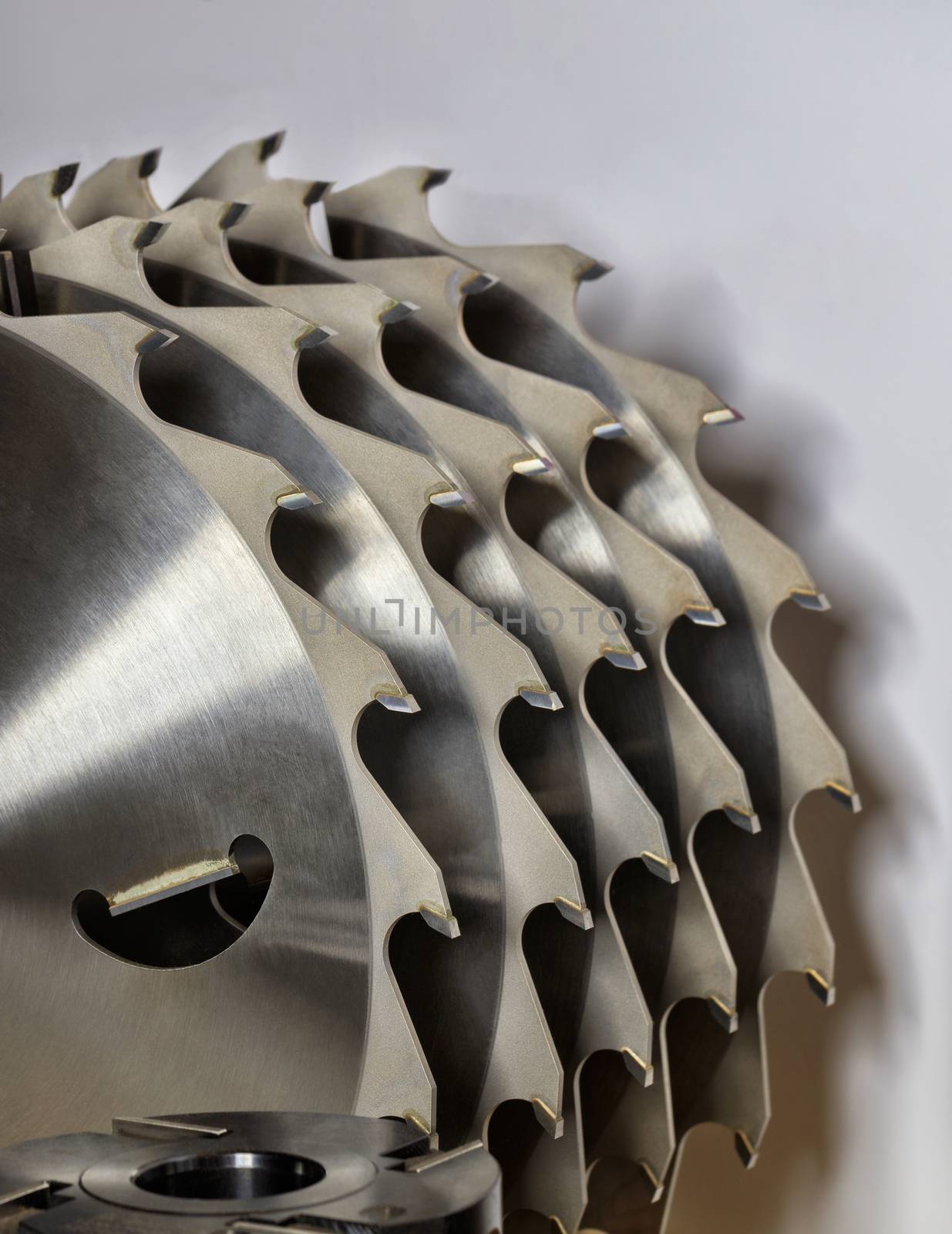 A segment of metal wood milling cutter and circular saws for cutting wood closeup.