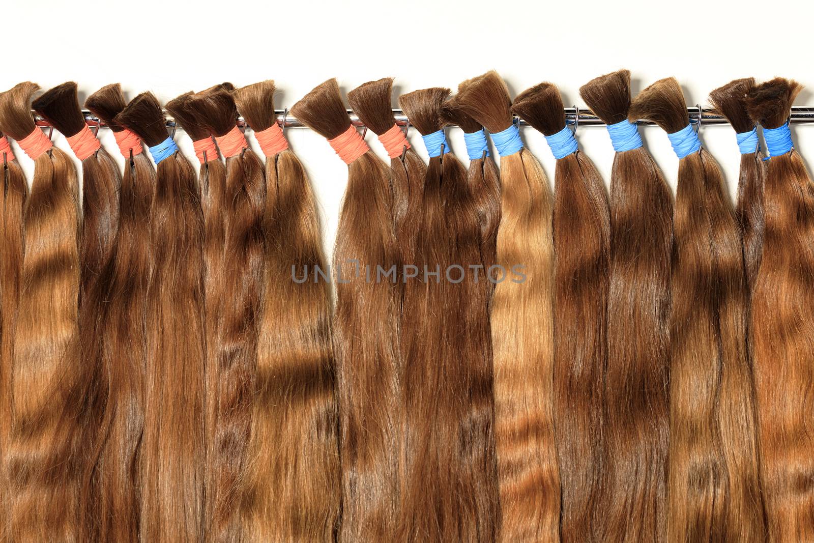 Haircare female hair, technology, style and beauty concept. Natural chocolate colored shiny healthy human hair bundles for extension and weave wigs making.