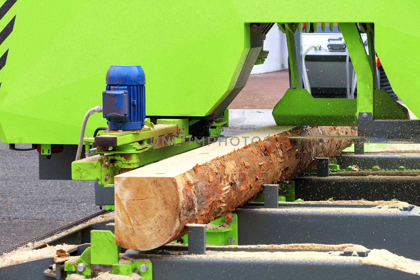 Woodworking, lumber, pine boards are made from large logs in a modern automatic sawmill.