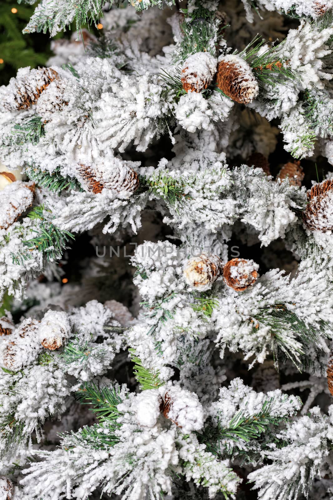 Christmas decorative cones on spruce decorative branches with white decorative snow. The concept of conservation of nature.