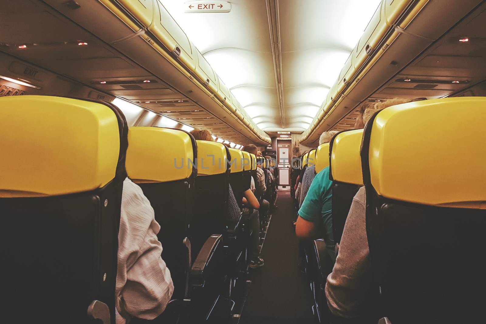 Interior view of a passenger airplane in an economic class during the flight ( vintage effect).