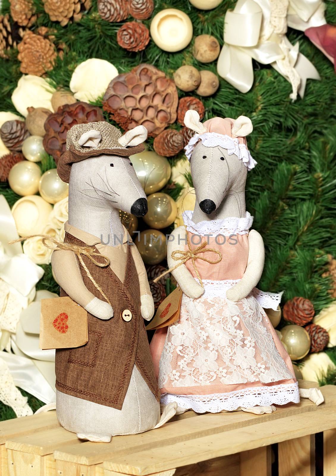 Pair of decorative toy mice festively dressed on the eve of the rat year on the background of the New Year tree. by Sergii