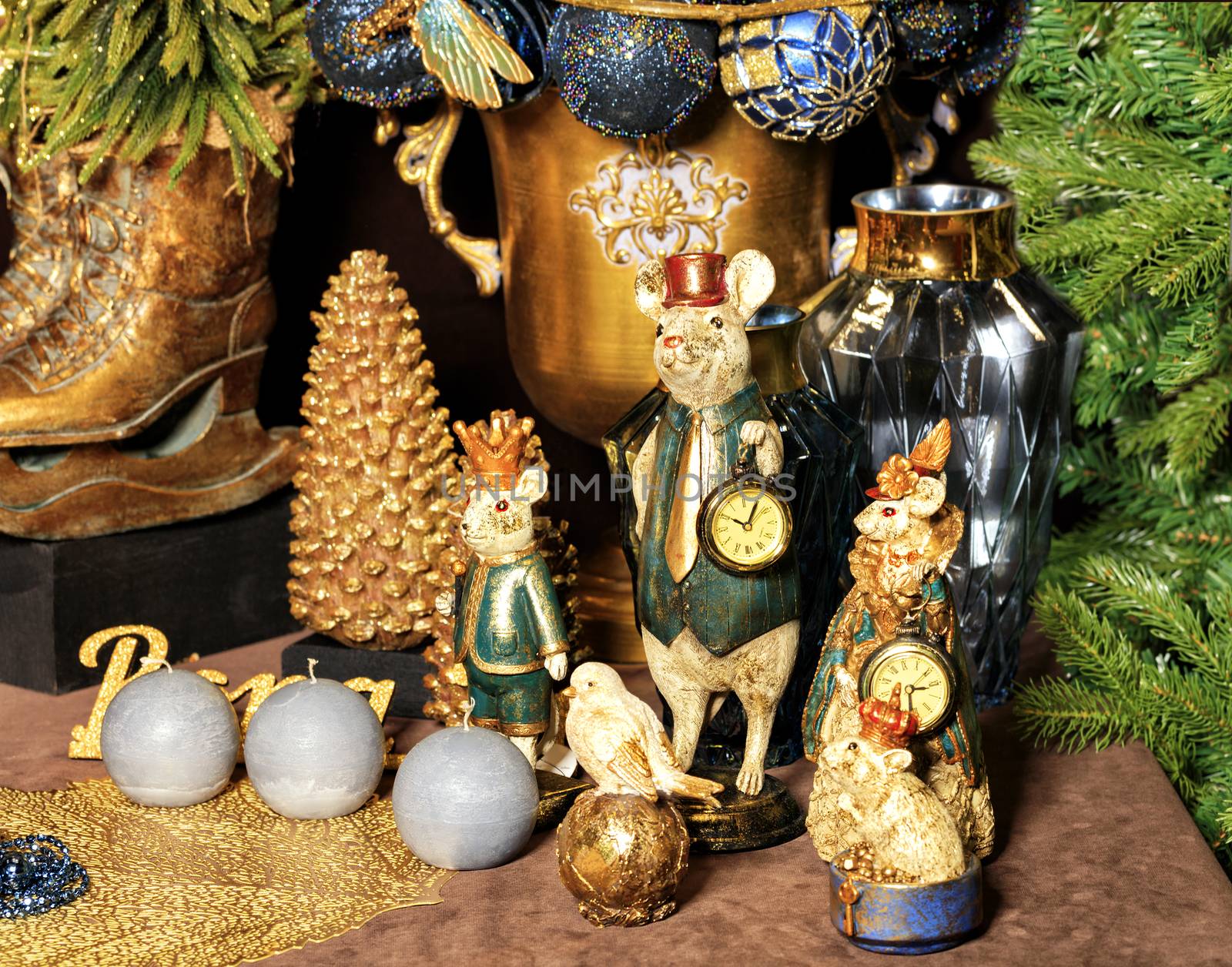 Family of decorative toy mice is festively dressed on the eve of the rat year against the backdrop of the New Year tree, candles and toys, 2020 symbol.