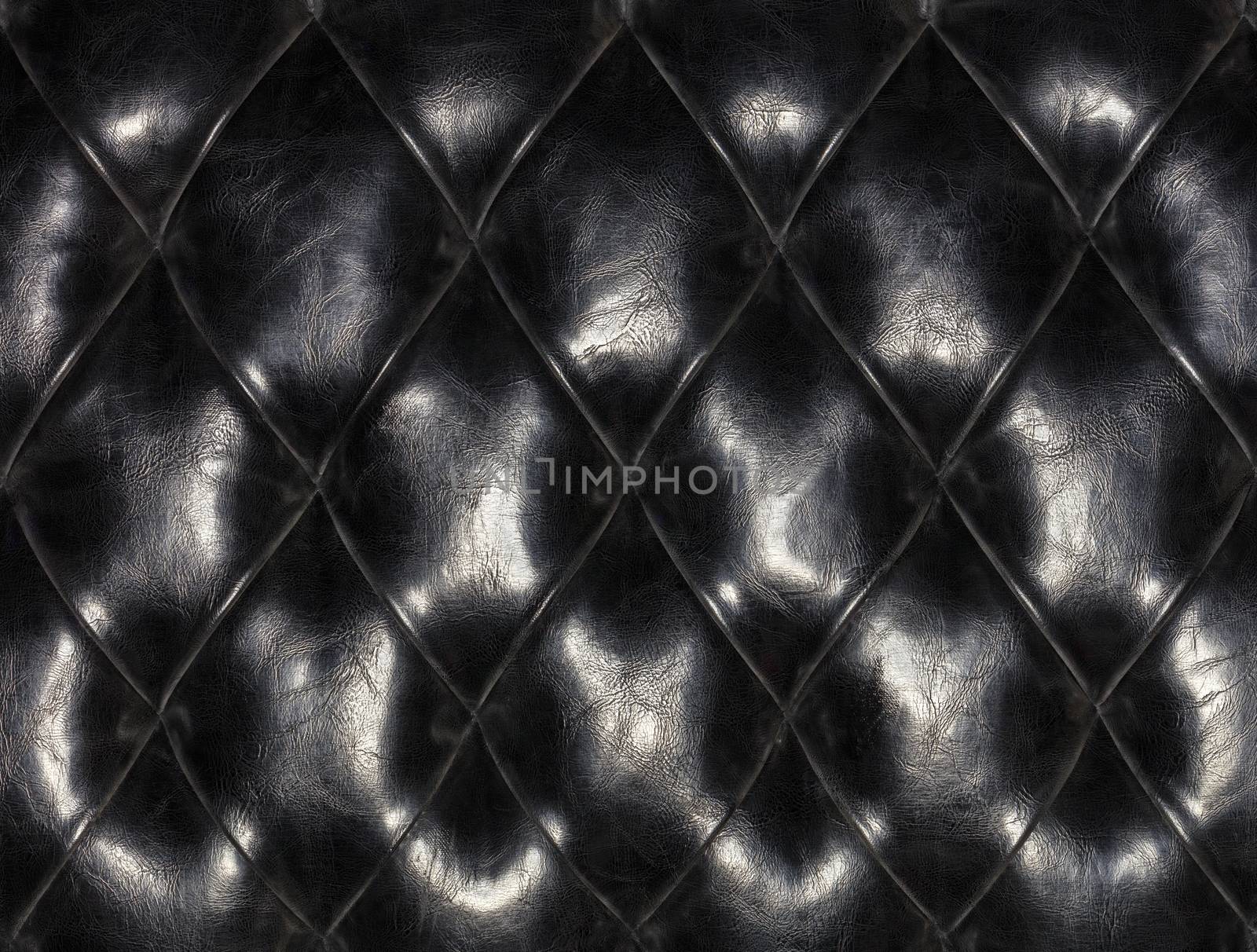Old black leather furniture background and texture stitched together in a diamond shape.