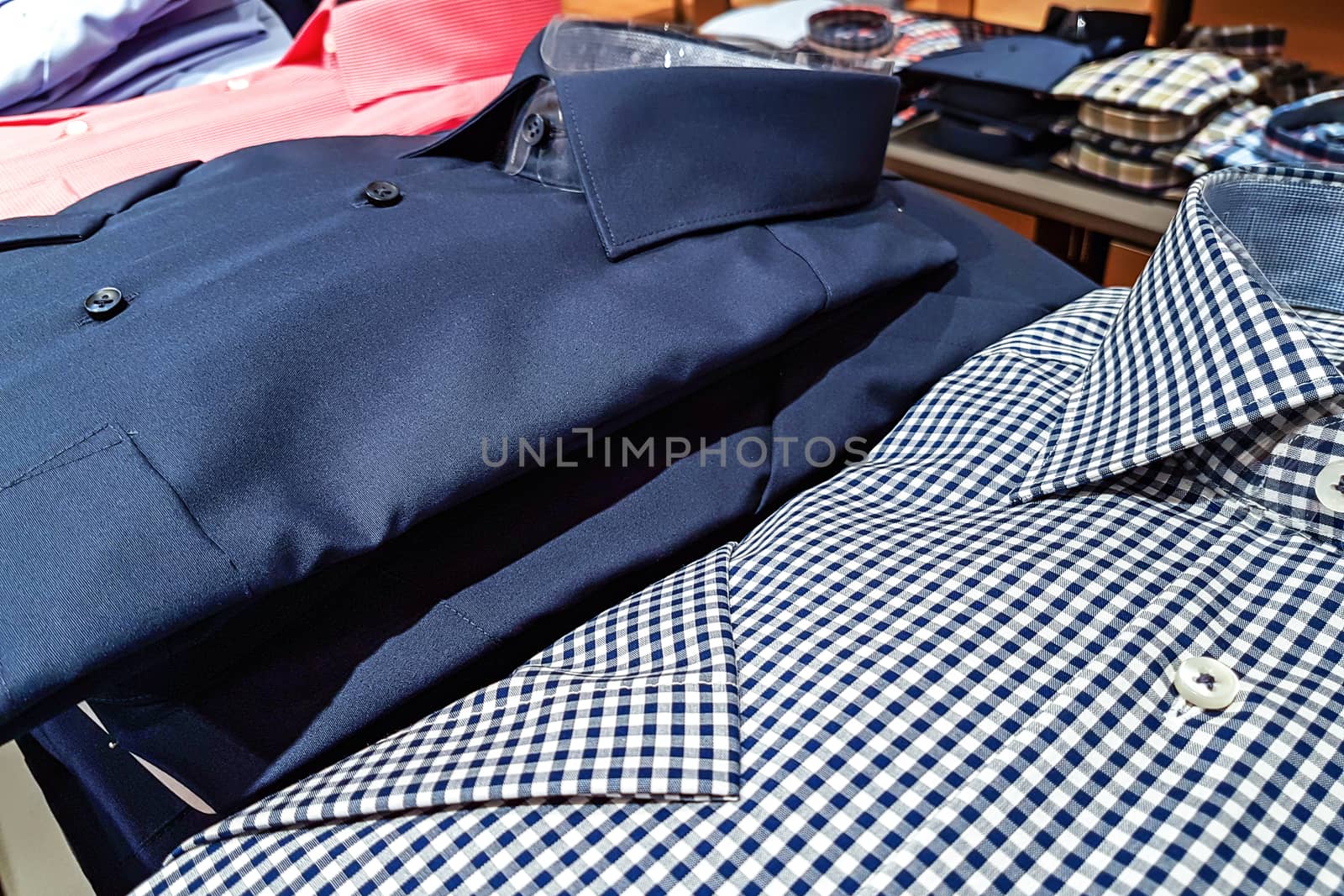 Clothing store - fashionable and elegant shirts for men in a row for sale.