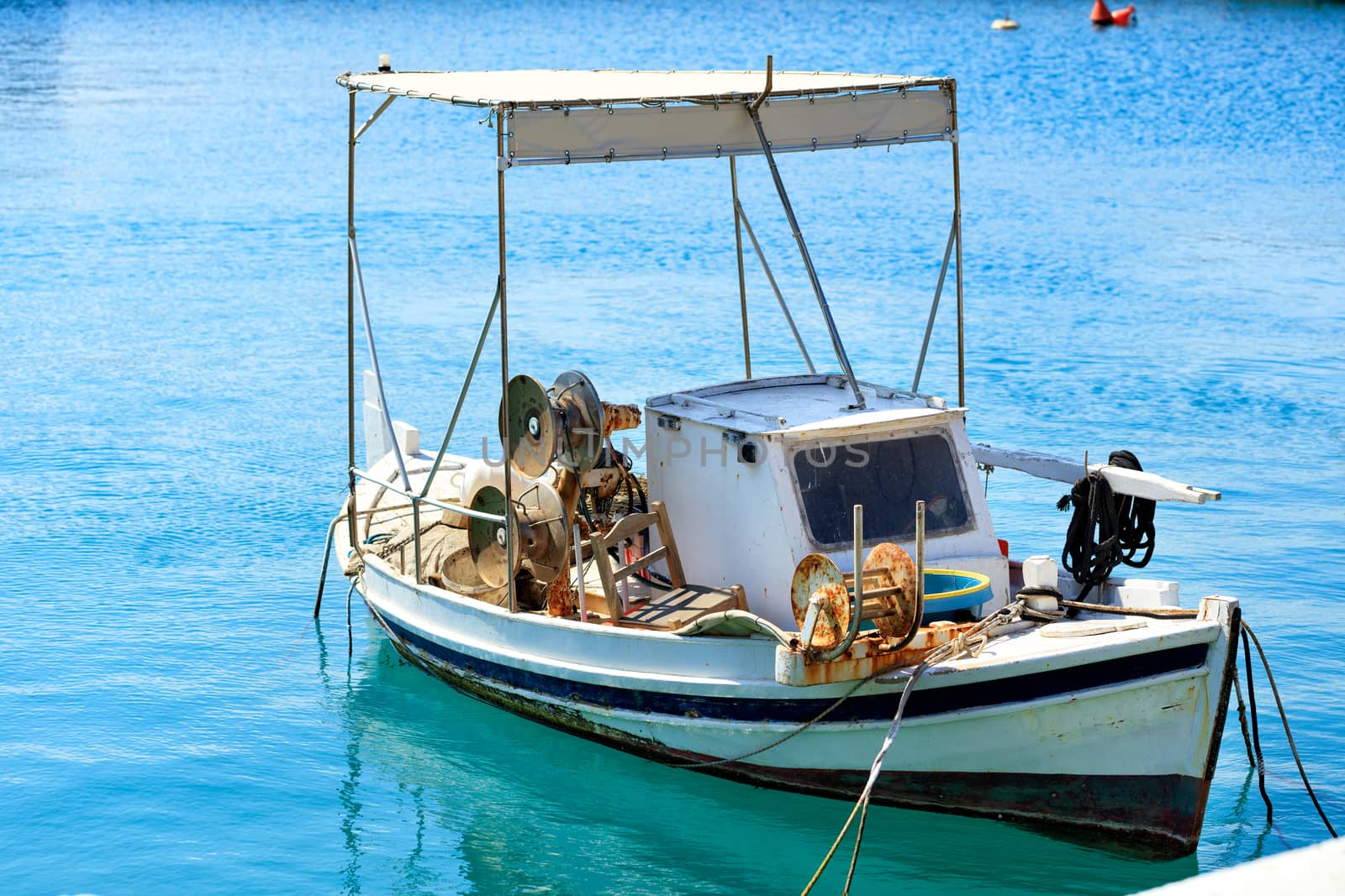 View of a small wooden fishing boat with fishing tackle. by Sergii