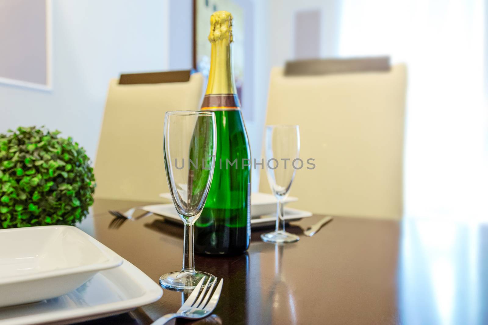 Lunch for two with a bottle of champagne with glasses on the table in a restaurant or living room (copy space)