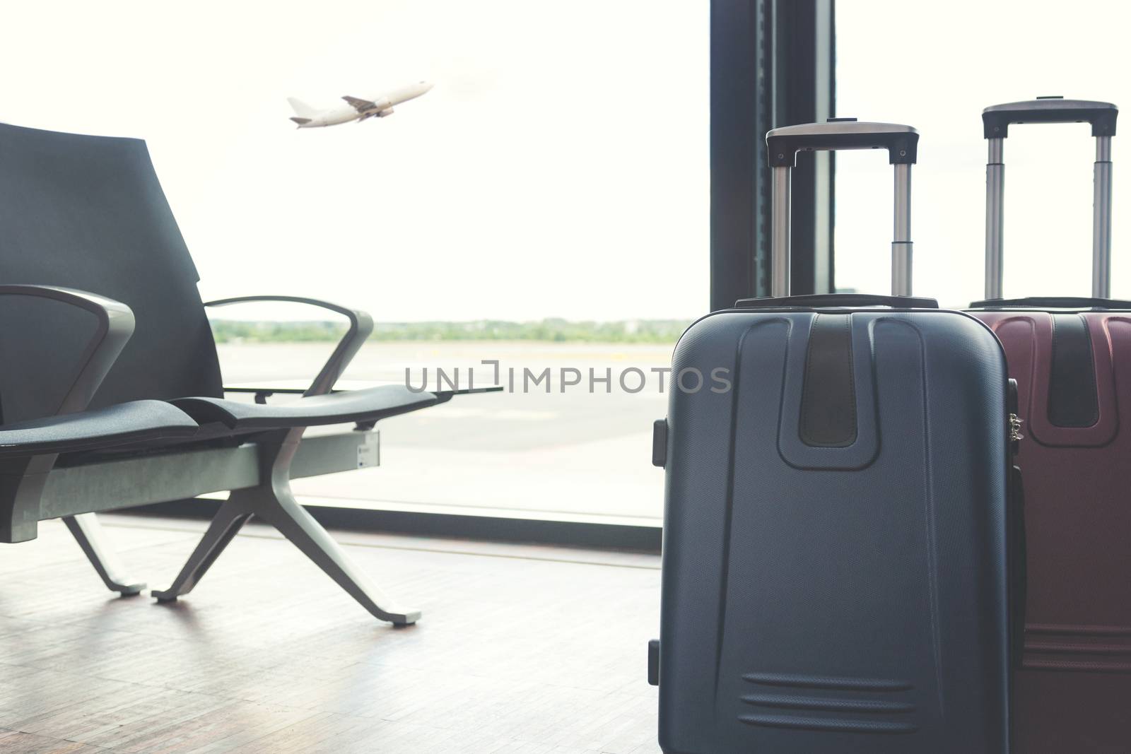 Travelling concept - big travel suitcases in the airport lounge
