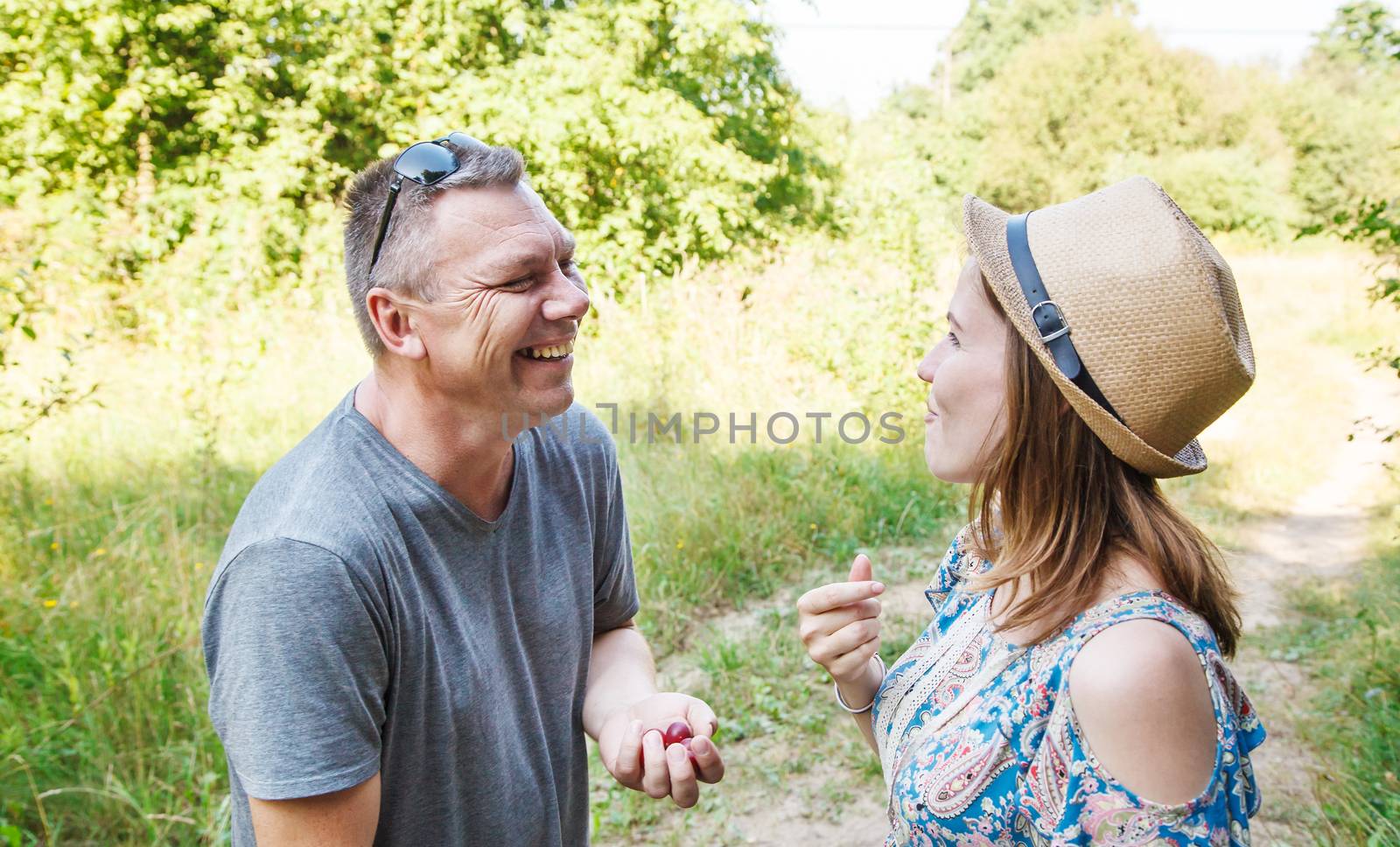 couple of lovers talk laughing in the forest on sunny summer day