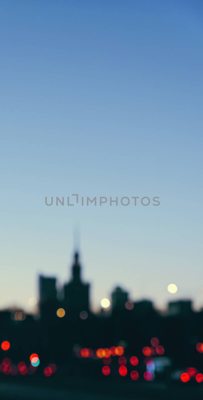 Blurry cityscape silhouette of a European city as background, evening view of Warsaw, Poland