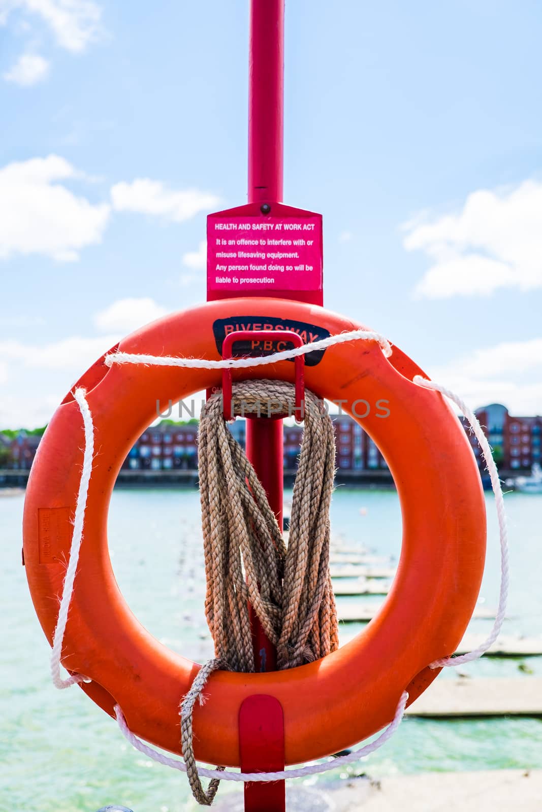 Lifebouy on post at Preston Docks in a sunny day by paddythegolfer