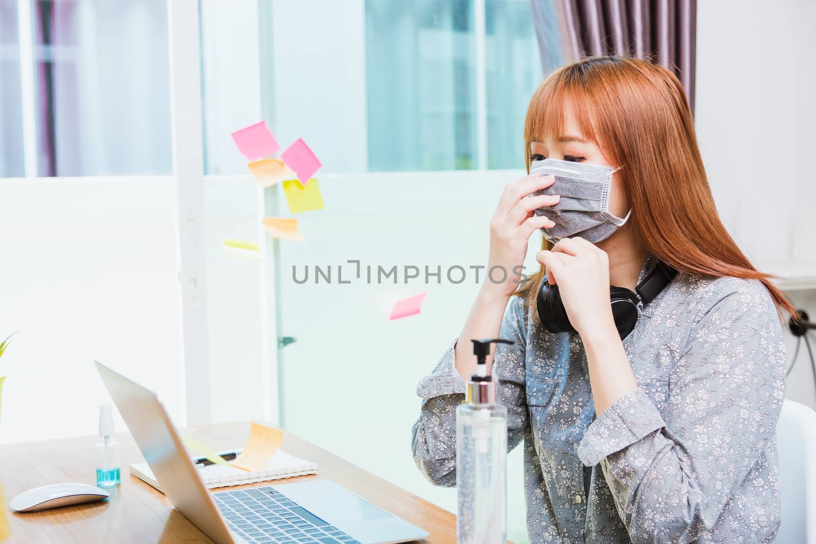Business woman wearing face mask protective working on desk with by Sorapop