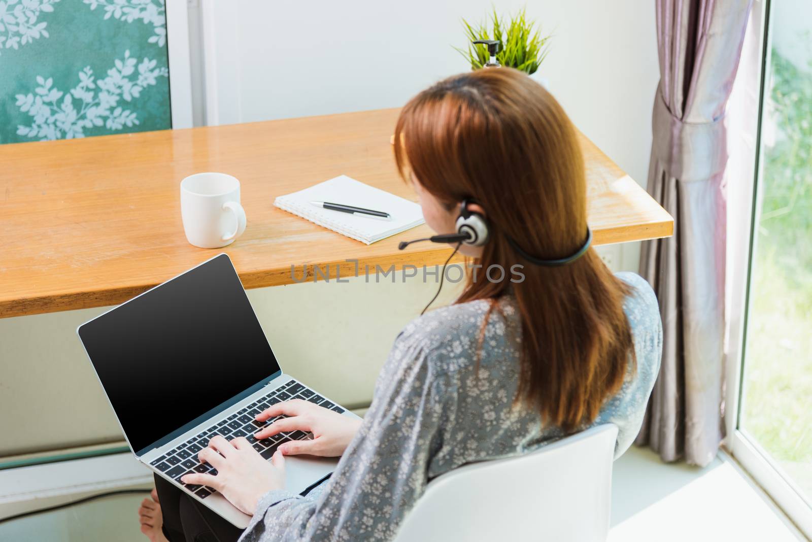 business woman wearing headphone call online conference video ca by Sorapop