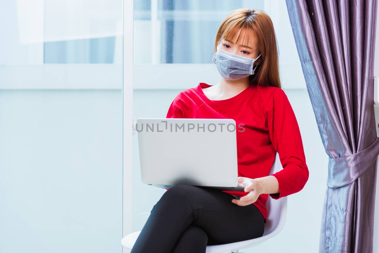 business woman sitting on chair wearing face mask protective wor by Sorapop