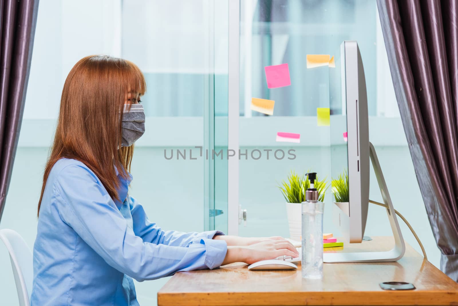 Asian businesswoman wear face mask protective working from home office with desktop computer under quarantines disease coronavirus making video call conference talking online to team consultation