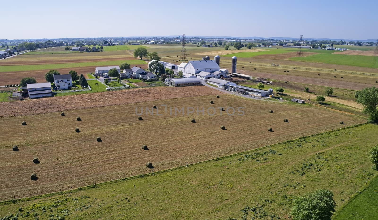 Aerial View of Amish Farmers Harvesting there Crops in Summer