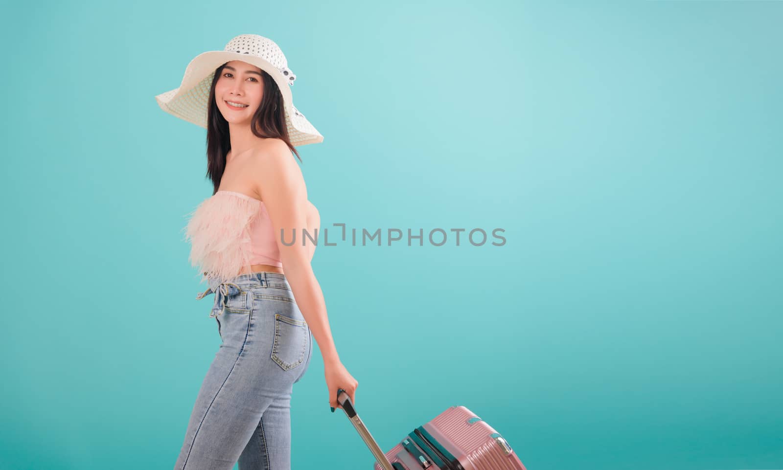 woman standing smile in summer trip to travel, hat with a suitca by Sorapop
