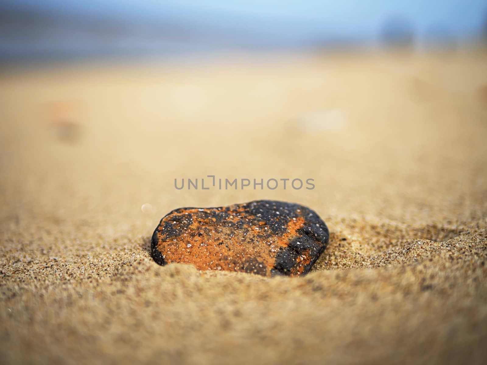 Heart shaped stone on the sand. Valentine day concept