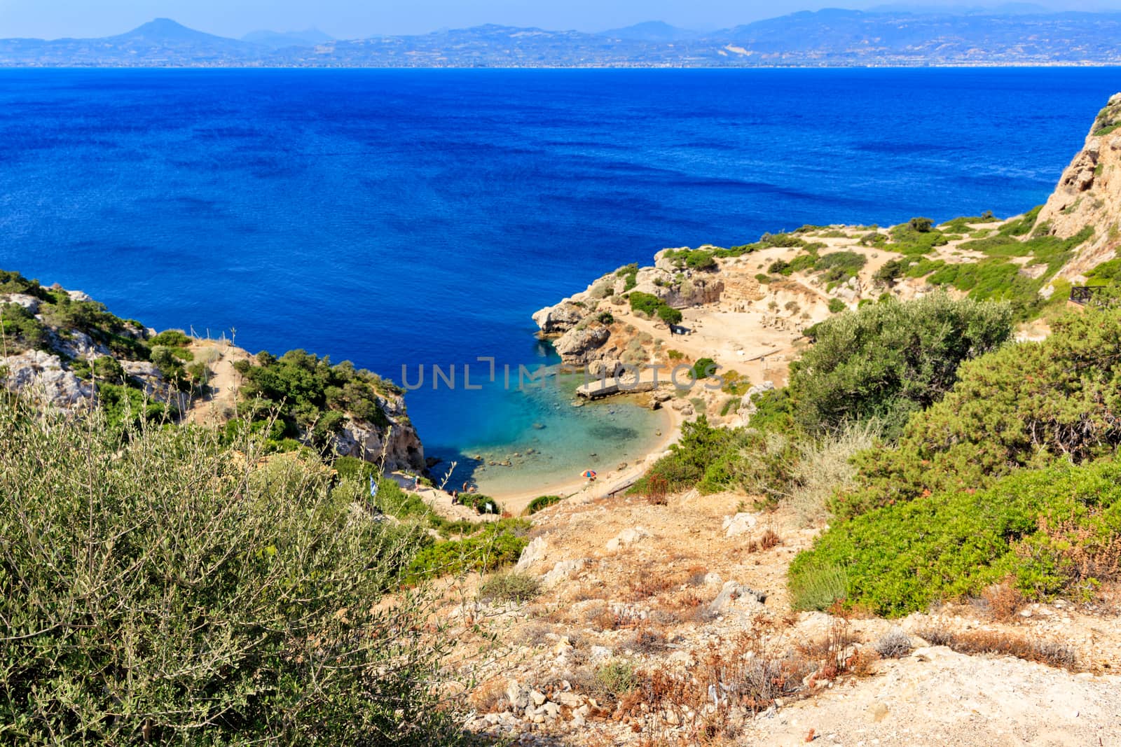 A beautiful view from a steep rocky slope on the Corinthian Gulf and the blue lagoon on the coast, a beautiful view from above. by Sergii